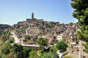 Panorama di Matera con i suoi storici sassi e il cielo blu, evidenziando la bellezza della città.